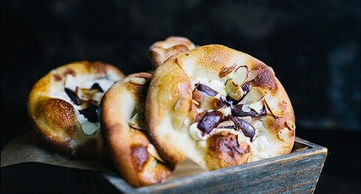Wood-fired flatbreads with cheese and almonds